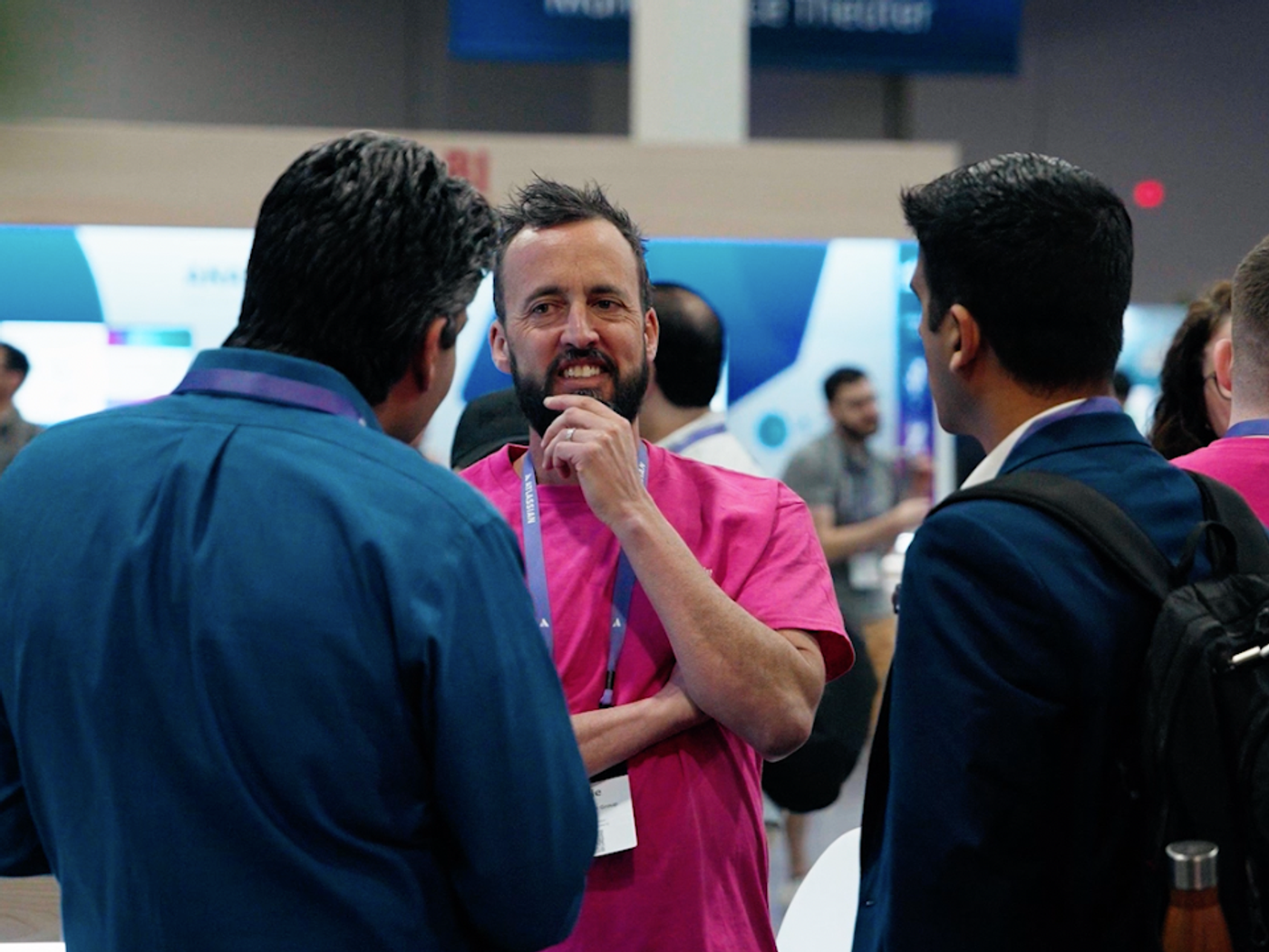 Jamie from ScriptRunner chatting to two people at an event