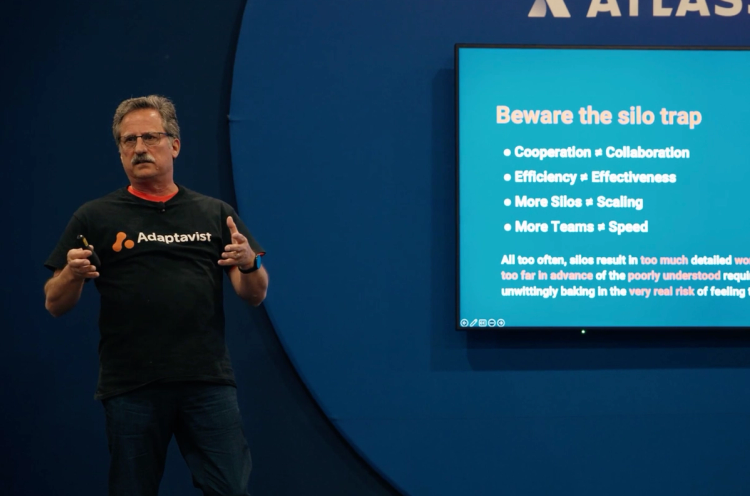 A person with an Adaptavist t-shirt giving a presentation