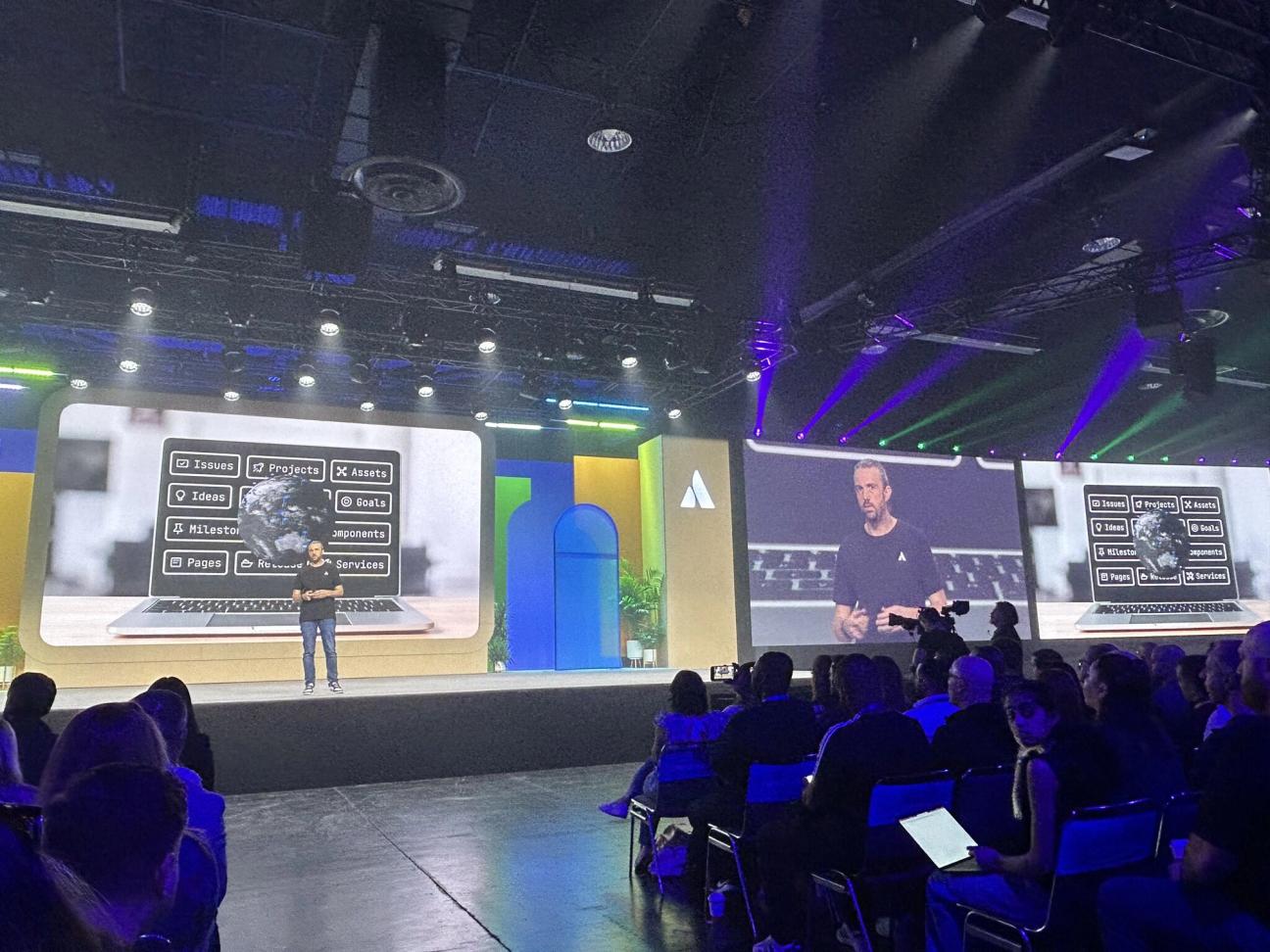 James Vowles, Team Principal at Atlassian Williams Racing Team, and Jenson Button, 2009 Formula 1 World Champion and Atlassian Williams Racing Ambassador, discussing high-stakes teamwork.