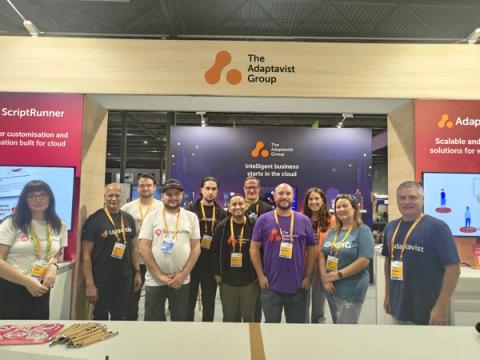 People standing in front of The Adaptavist Group booth at Team '25 Europe