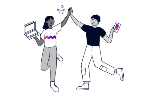 Two colleagues high five: one holding a laptop and the other a mobile device.