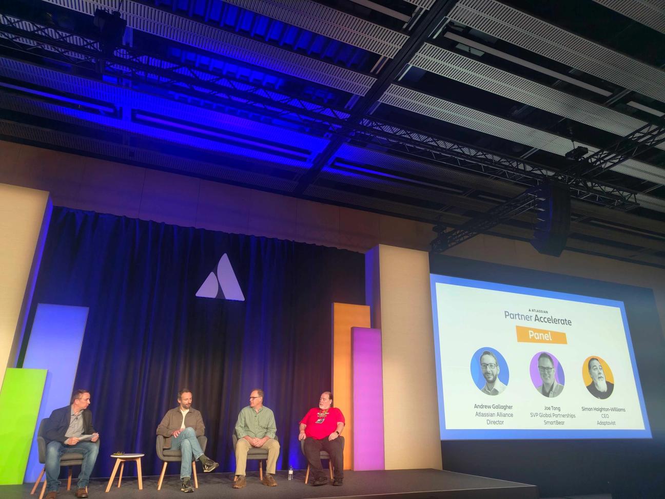 The Adaptavist Group CEO Simon Haighton-Williams on stage at Team with three other people