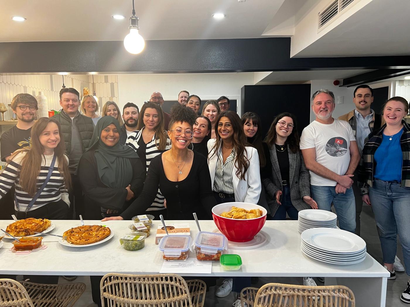 Maria with colleagues at a pot luck event in the office