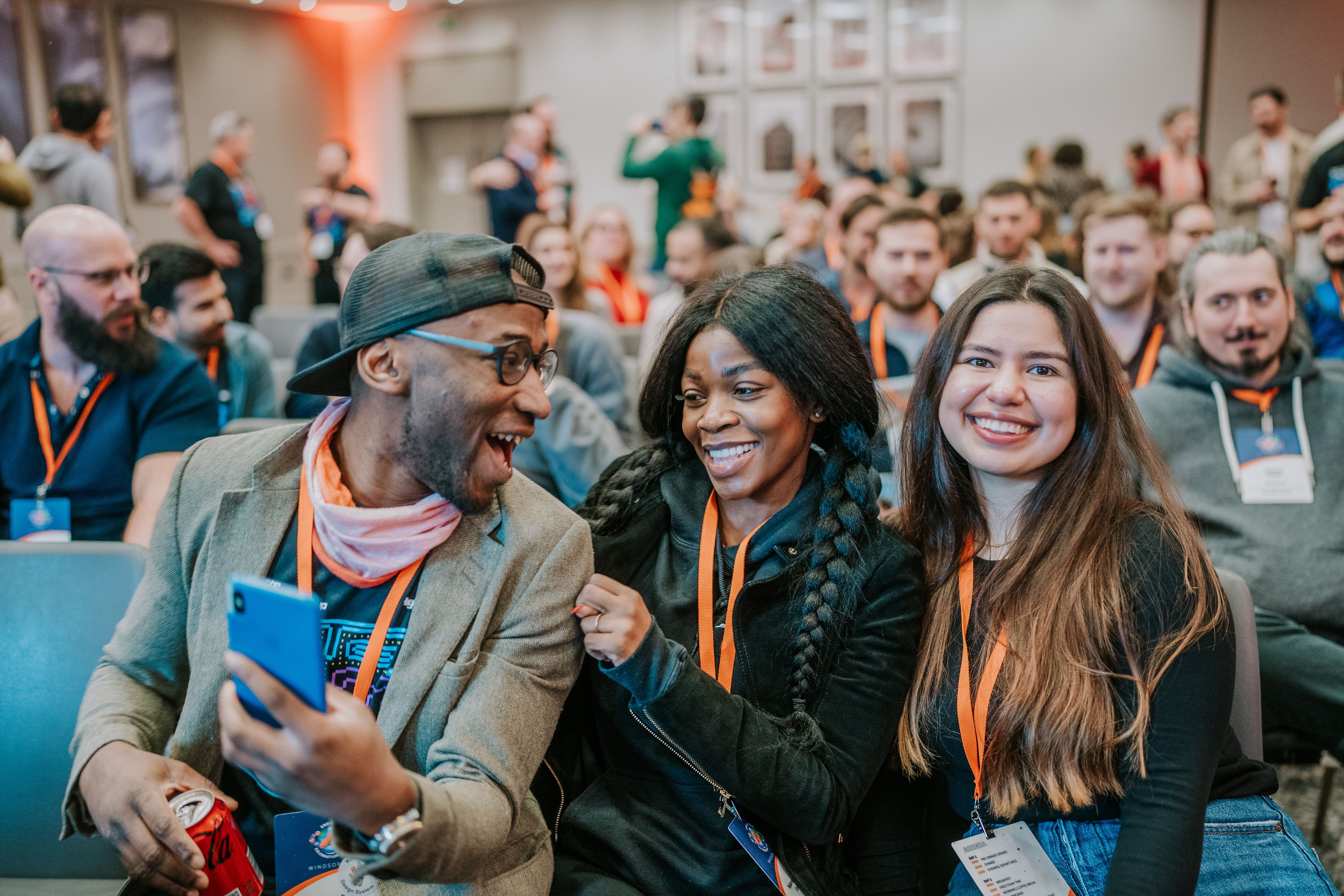 A group of colleagues smiling and laughing together at an event