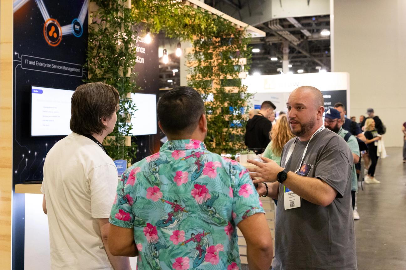 Our expert chatting to two Atlassian Team '24 Attendees