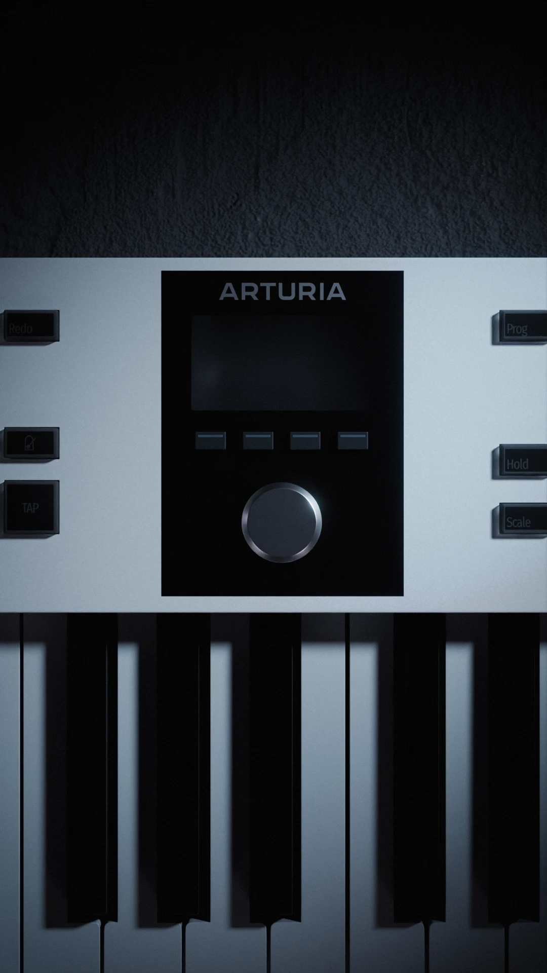 Close-up of an Arturia KeyLab keyboard’s central display, silver control knob, and piano keys under dim, cool lighting.