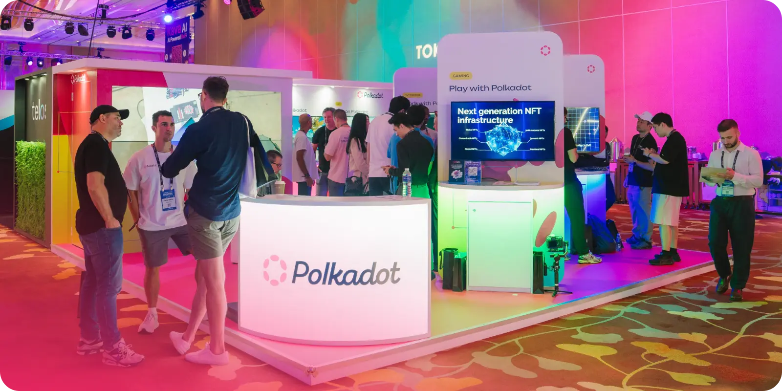 People in deep discussion at the Polkadot booth at Token 2049 in Singapore