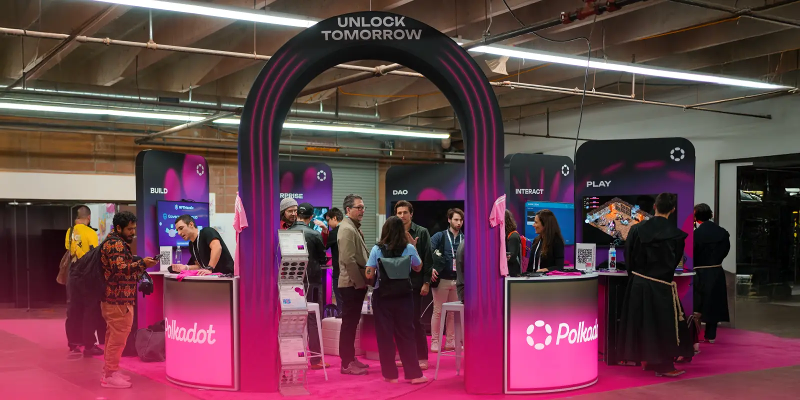 Polkadot’s immersive booth at ETHDenver 2025, featuring interactive zones for building, DAOs, gaming, and enterprise blockchain solutions.