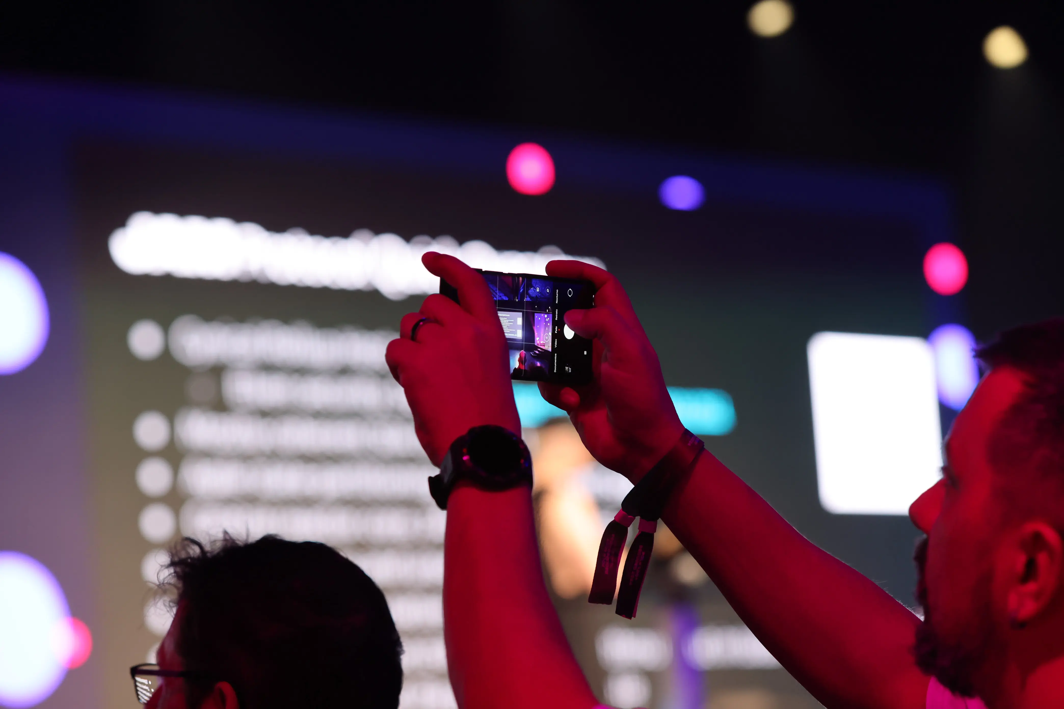 An audience member at Decoded 2024 takes a photo of Gavin Wood's keynote presentation on digital individuality.