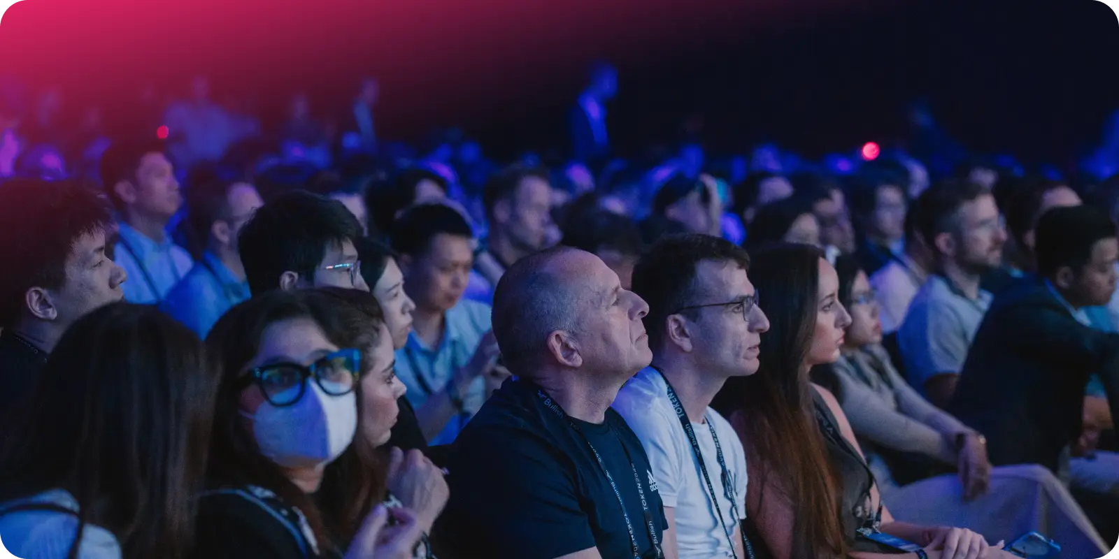 A crowd of people at token 2049 in Singapore watching a keynote presentation