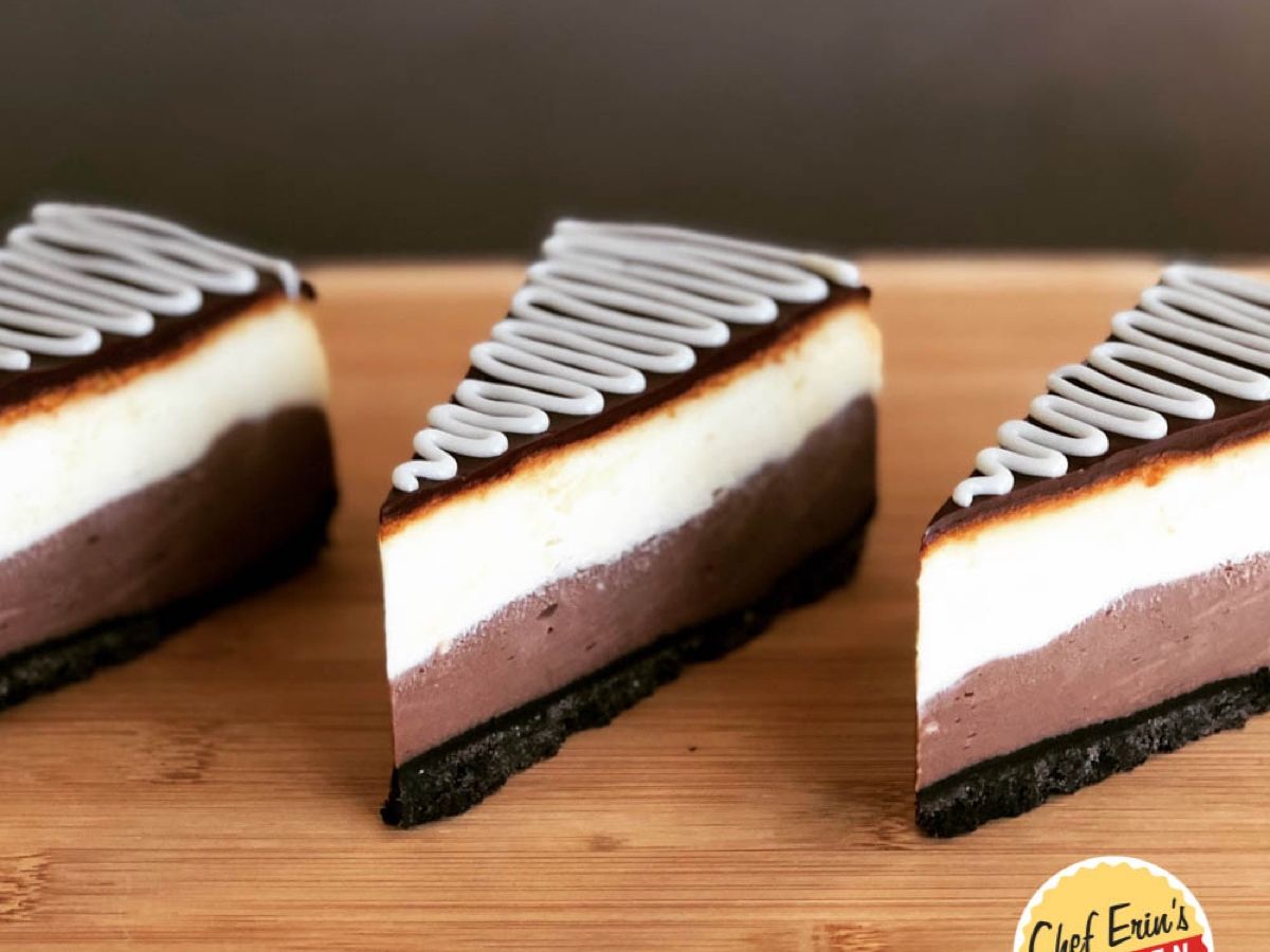 A slice of Ebony and Ivory cheesecake showing its dark and white chocolate layers