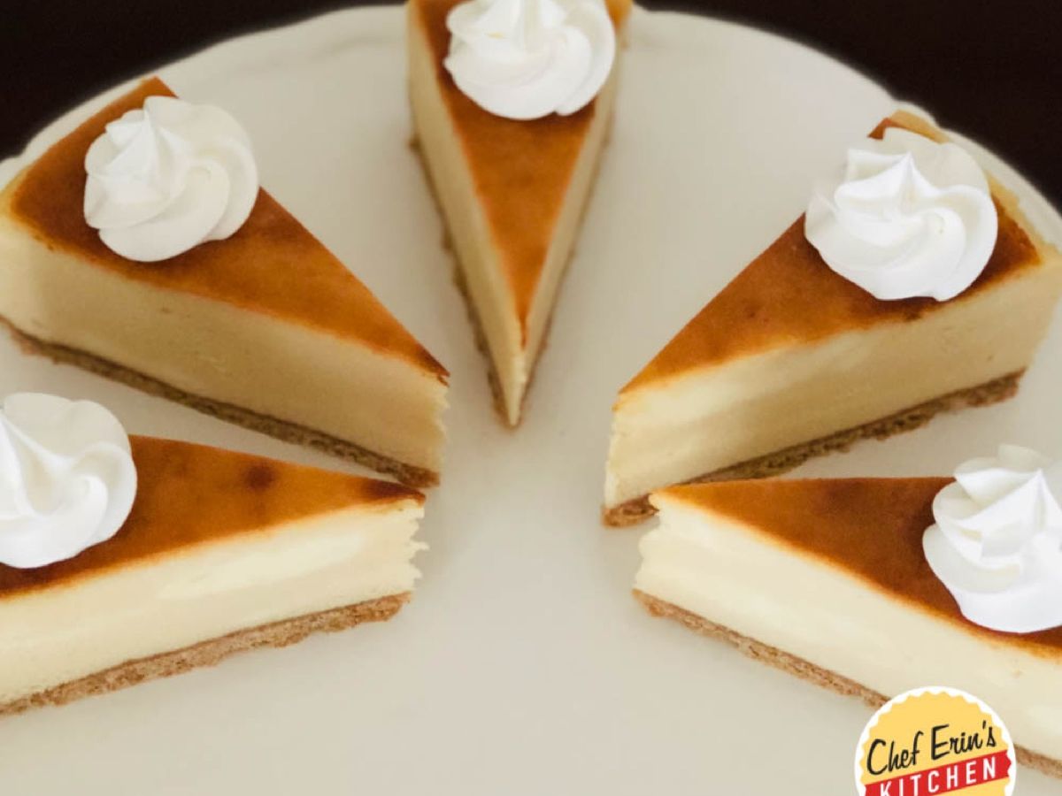 A slice of White Russian cheesecake topped with whipped cream