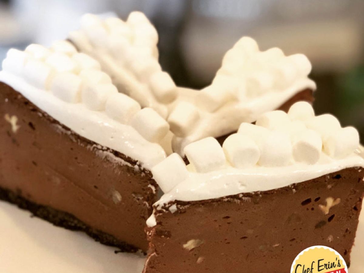 A slice of rocky road cheesecake topped with marshmallow and pecans