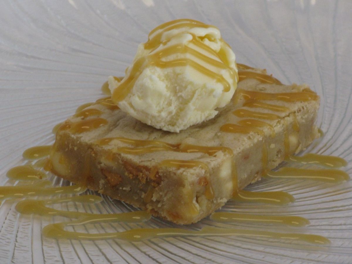 A pan of blondies cut into squares with white chocolate chips
