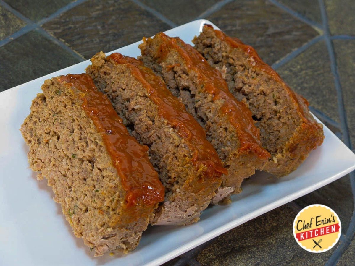 A sliced meatloaf topped with a glossy ketchup glaze