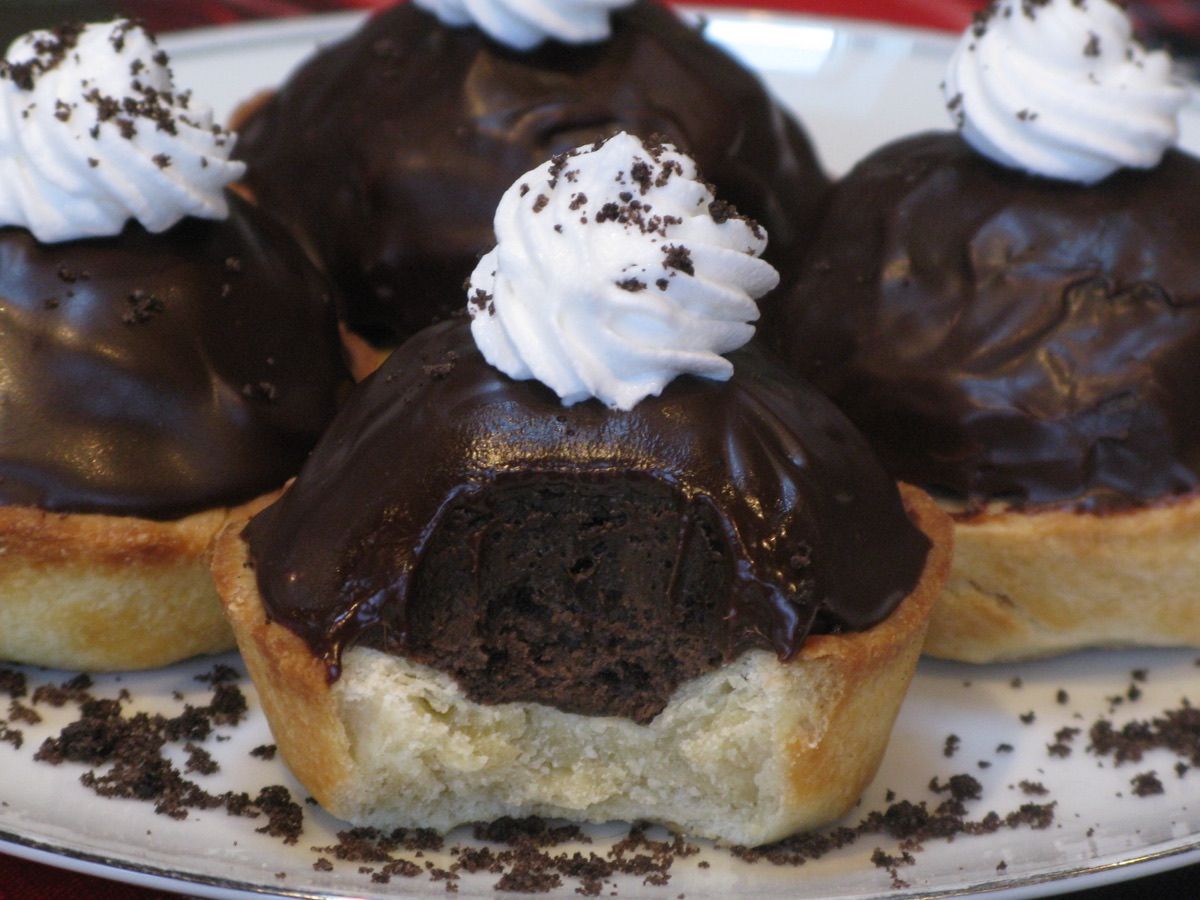Mini Oreo truffle tarts topped with chocolate ganache and whipped topping