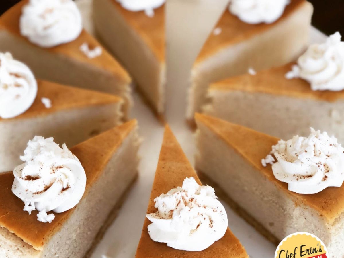 A slice of coquito cheesecake garnished with whipped topping, cinnamon, and coconut