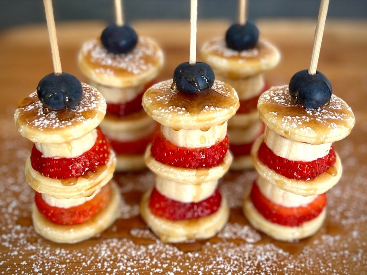 Mini pancake skewers layered with strawberries, bananas, and blueberries
