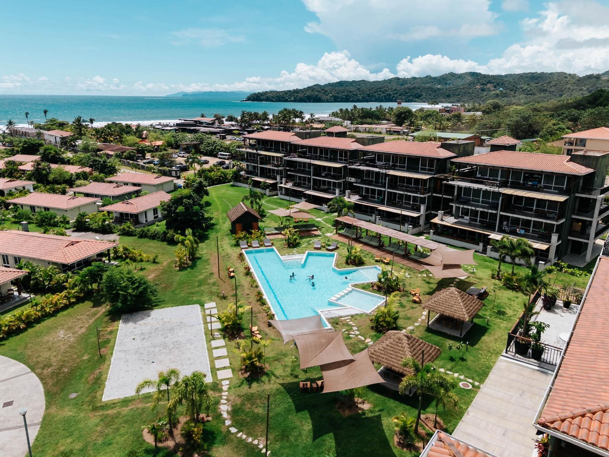 Aerial view of the Blue Venao buildings and the pool, with Playa Venao bay behind