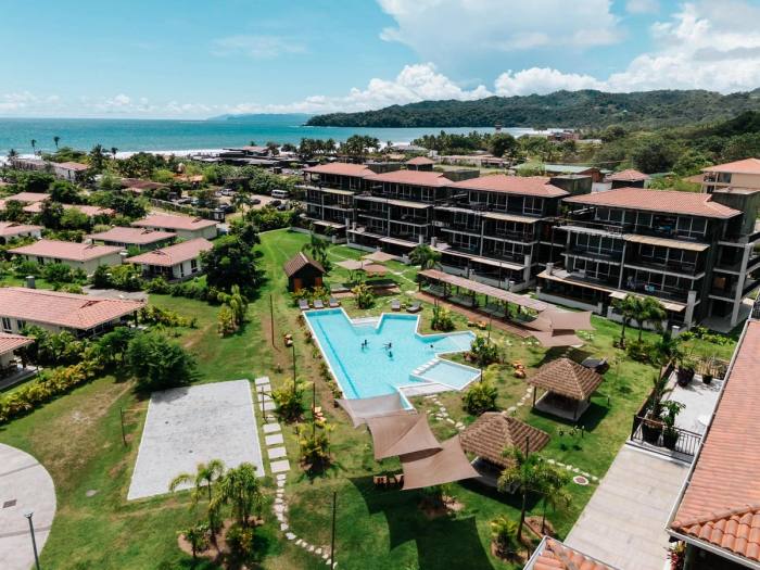 Aerial view of the Blue Venao buildings and the pool, with Playa Venao bay behind