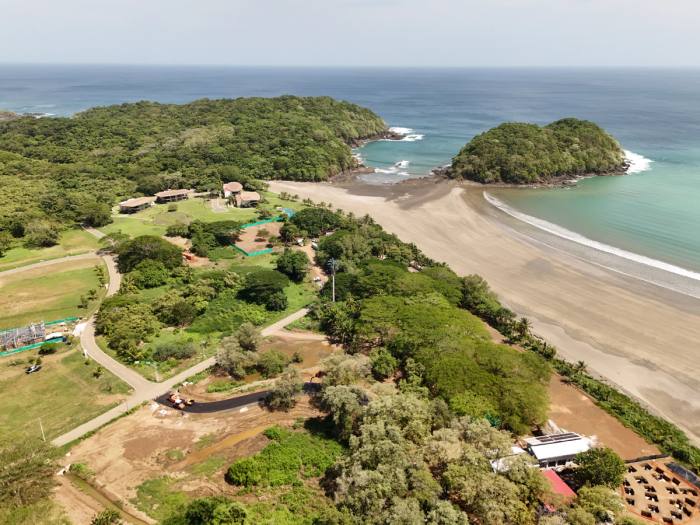 Aerial of the Villa Marina site: the existing lodge, the beach, the headland and the earthworks for the next phase