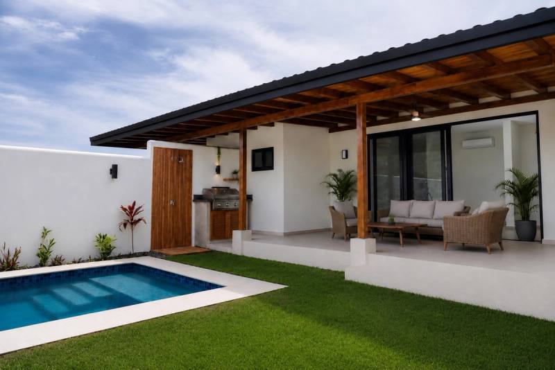 Covered terrace and pool along the back of the house