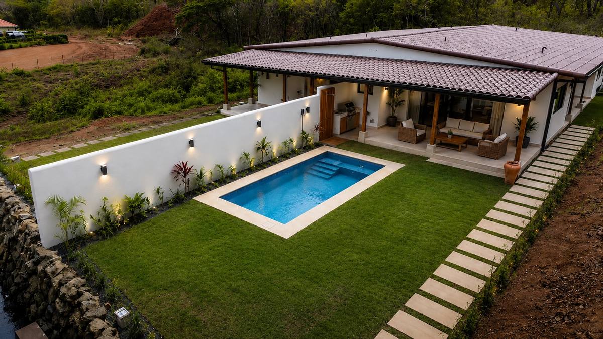 The back garden with the pool, lawn and stepping stones, seen from above