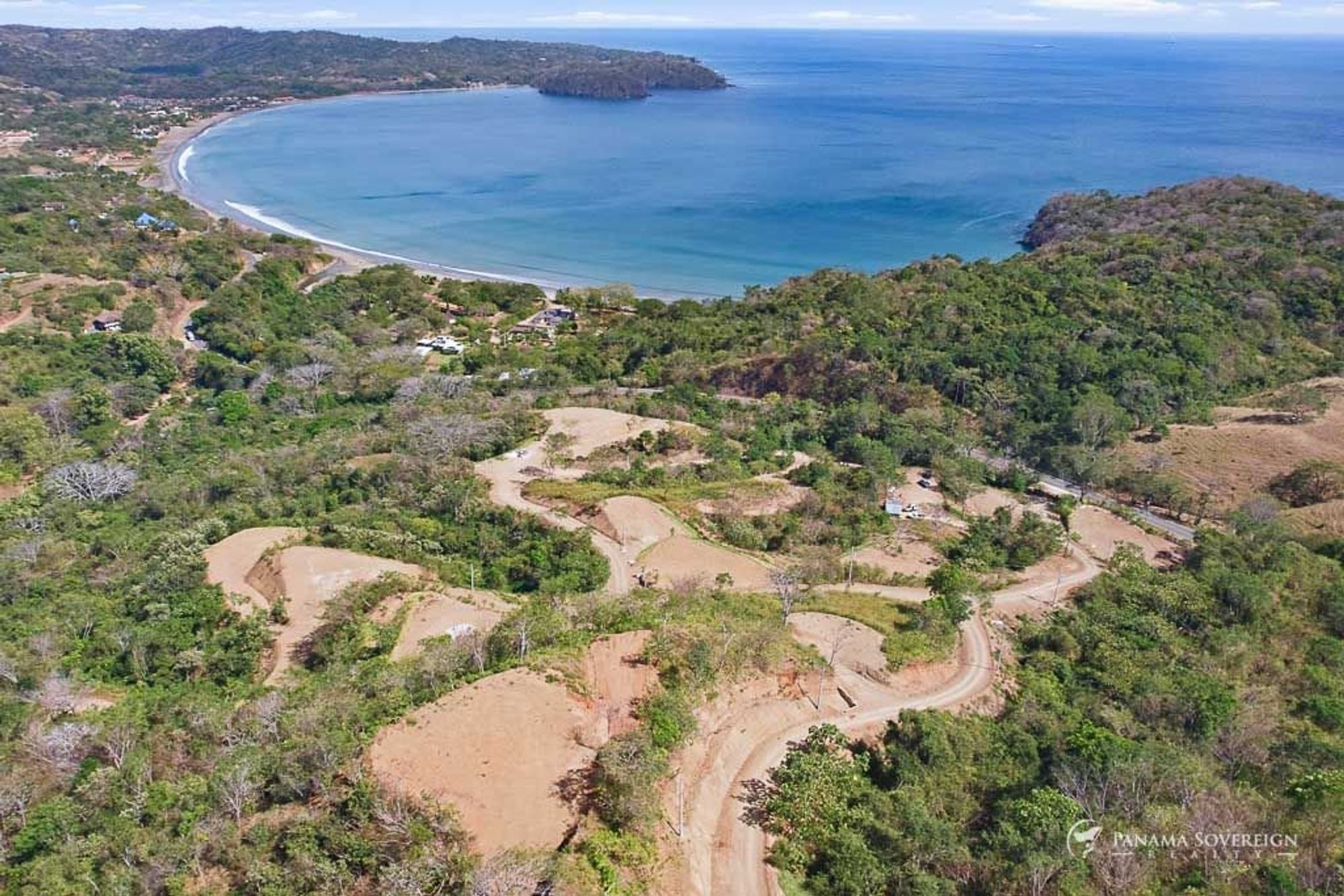 The Las Balsos hillside with its access roads, the bay in the distance