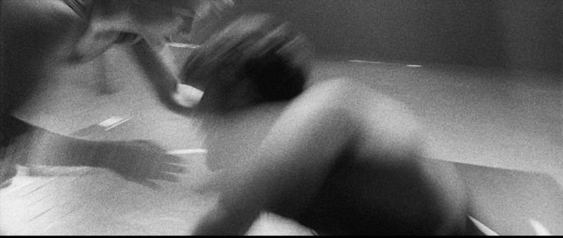 Black and white film photo of Olympic wrestler Helen Maroulis grappling in motion with heavy grain and blur.