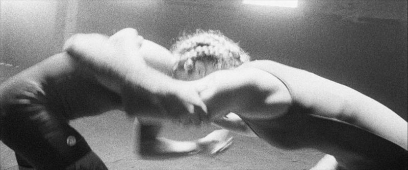 Black and white film photography of Olympic wrestler Helen Maroulis grappling intensely with an opponent.