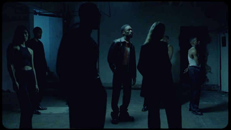 Group of people in dimly lit underground space, cinematic mood with film photography aesthetic