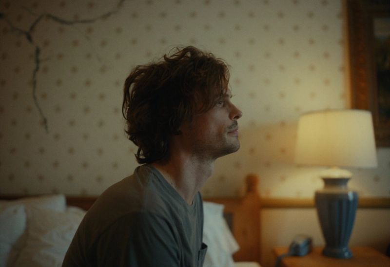 Will Mayer in a dimly lit bedroom, gazing upward with contemplative expression.