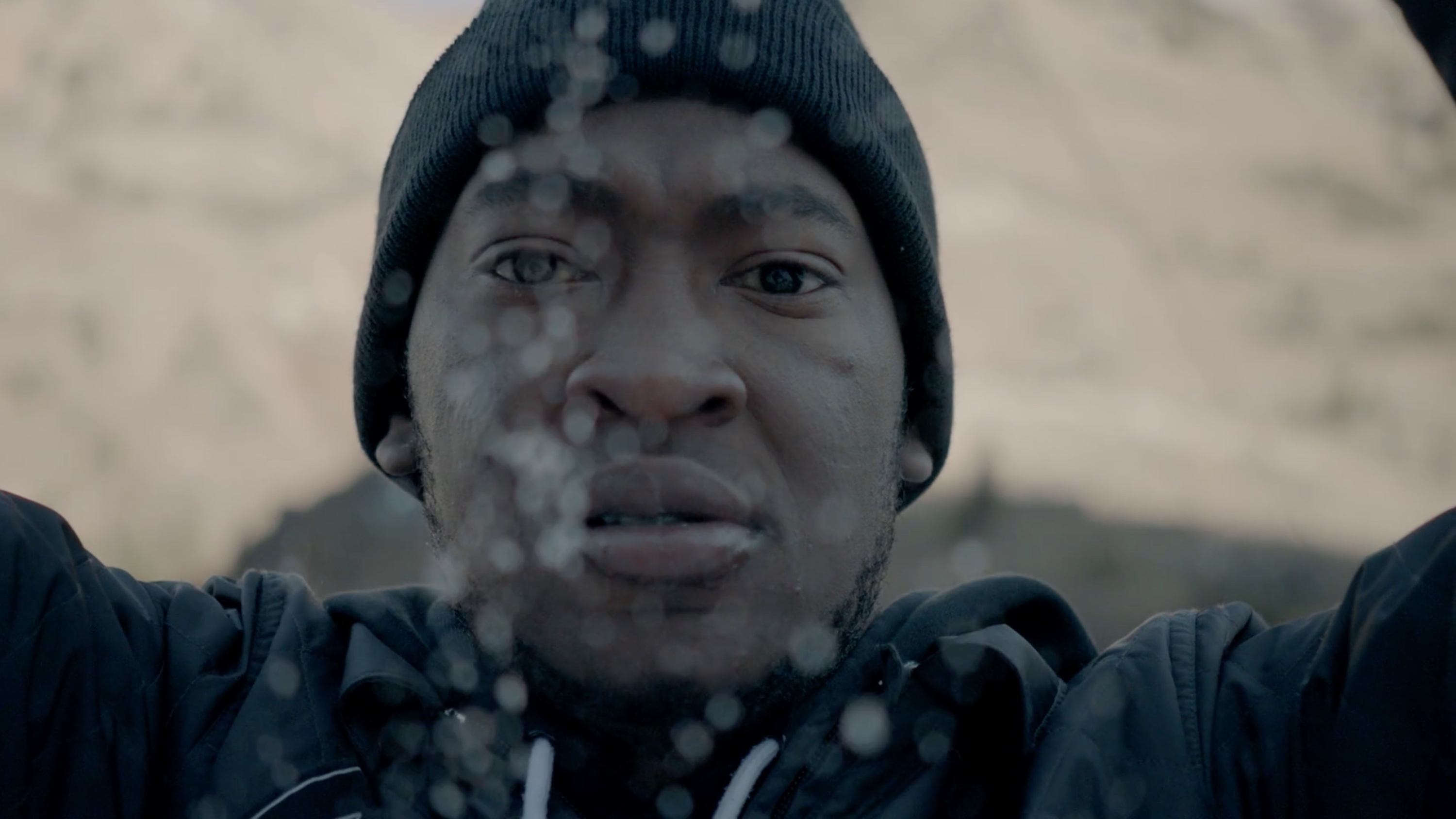 Cinematographer Ian Rigby on Antelope Island, Utah, in snowy conditions with raindrops visible