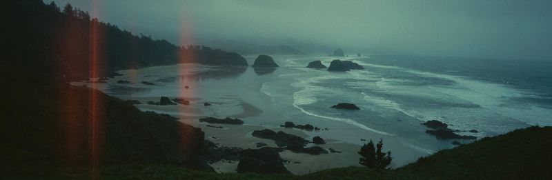 Misty Oregon coastline with rocky outcrops and ocean waves
