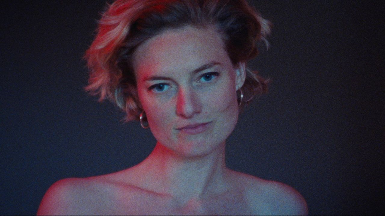 Portrait of Callie Hernandez with red and blue lighting, DOP Ian Rigby