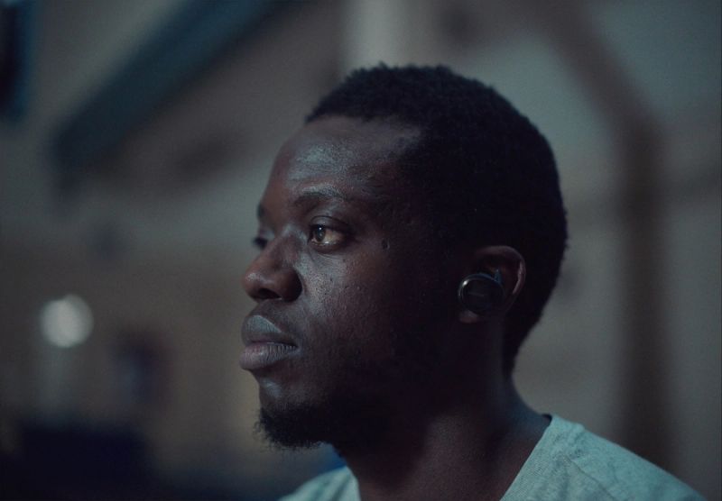 Cinematic profile portrait of Reggie Jackson looking left with cool lighting and large earring.
