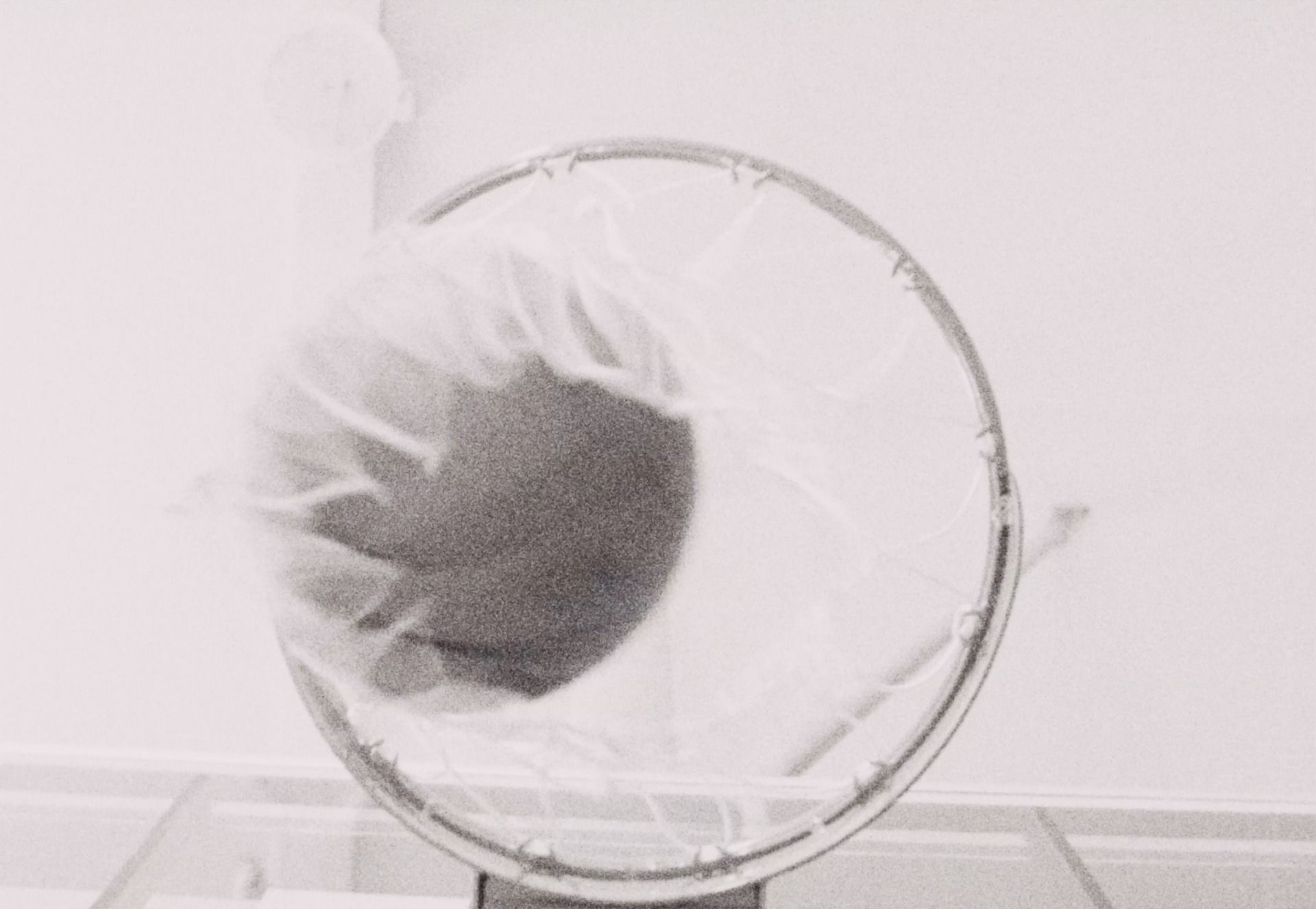 Reggie Jackson basketball shot through hoop with grainy film texture.
