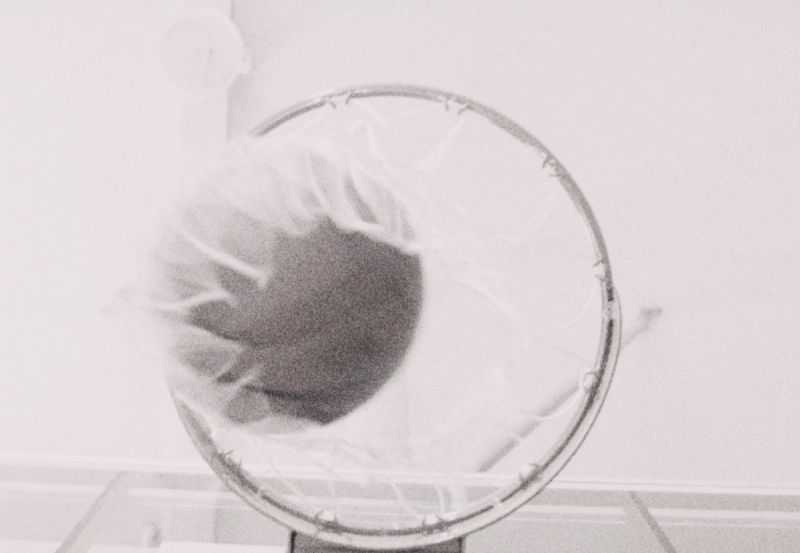 Reggie Jackson basketball shot through hoop with grainy film texture.