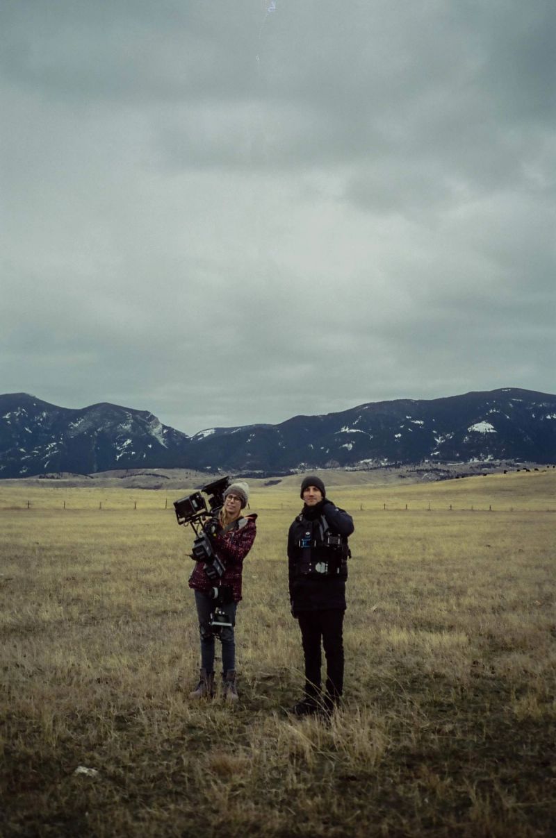 Ian Rigby and director Keenan Wetzel on set in open field with mountains, holding Steadicam gear