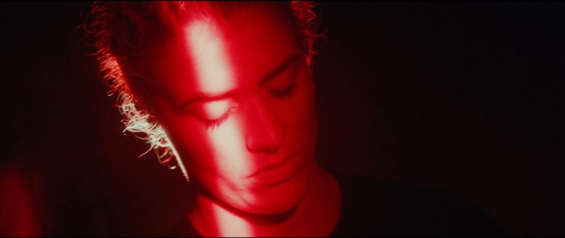 Close-up portrait of Olympic wrestler Helen Maroulis bathed in dramatic red lighting.