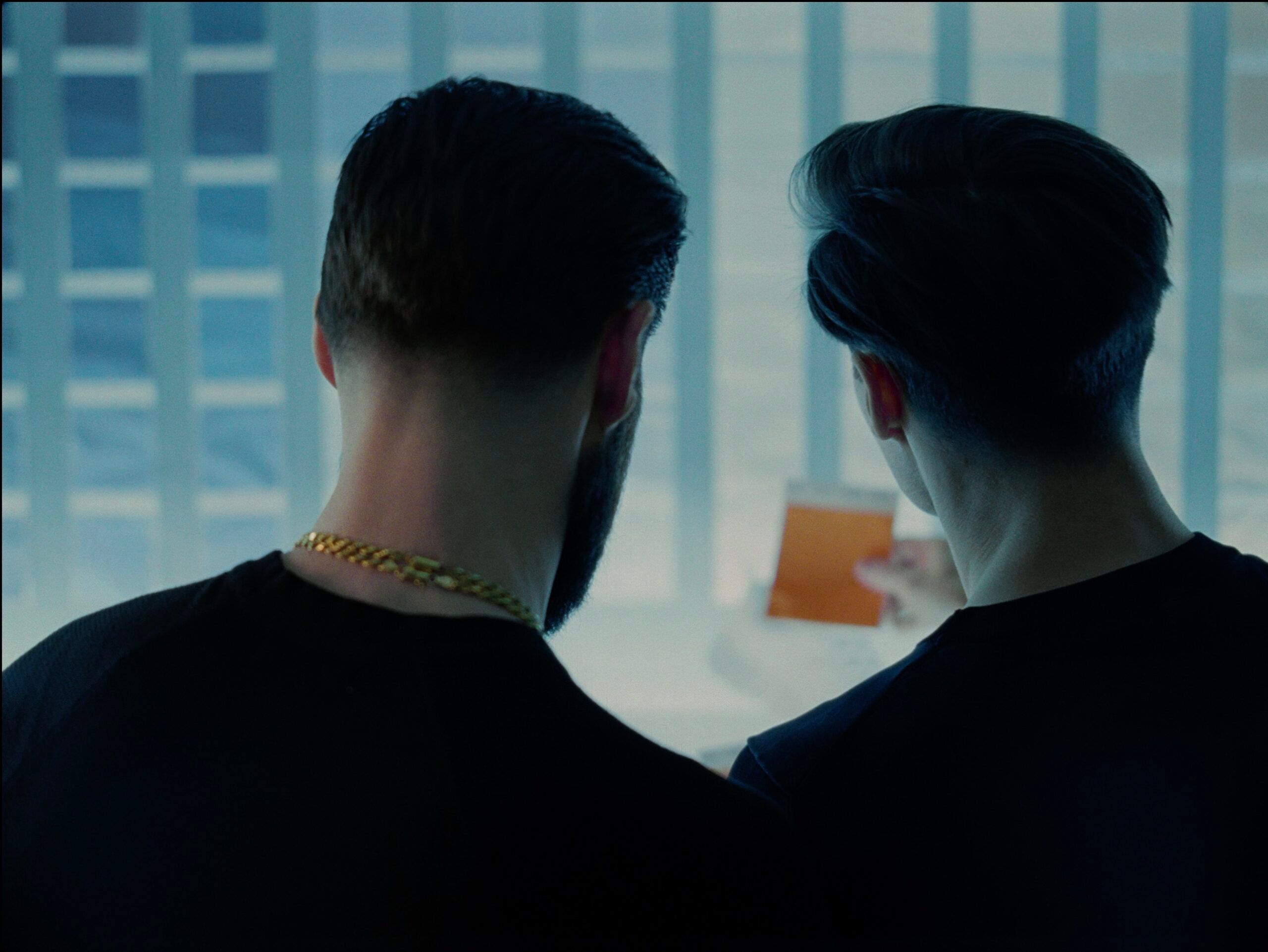 Behind-the-scenes still from Rolls Royce Inspiring Greatness project showing two men looking out a window.