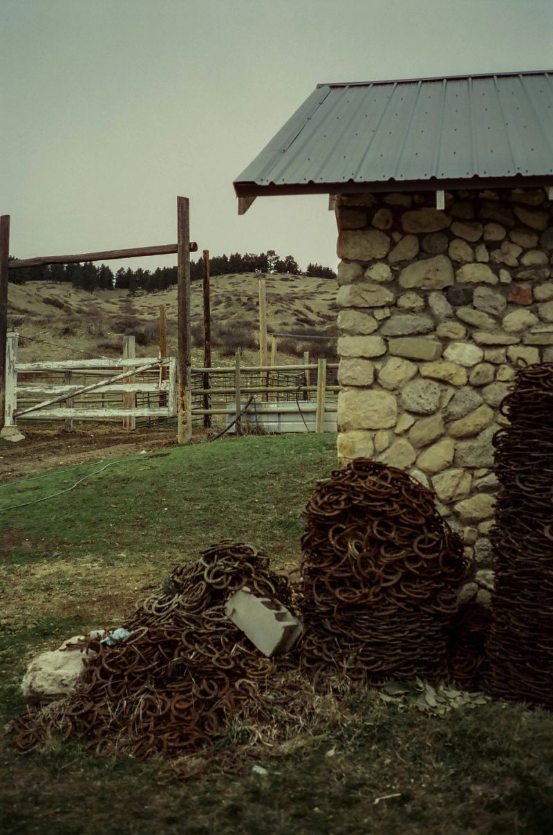 Piles of horseshoes and a stone building on a ranch in Montana.