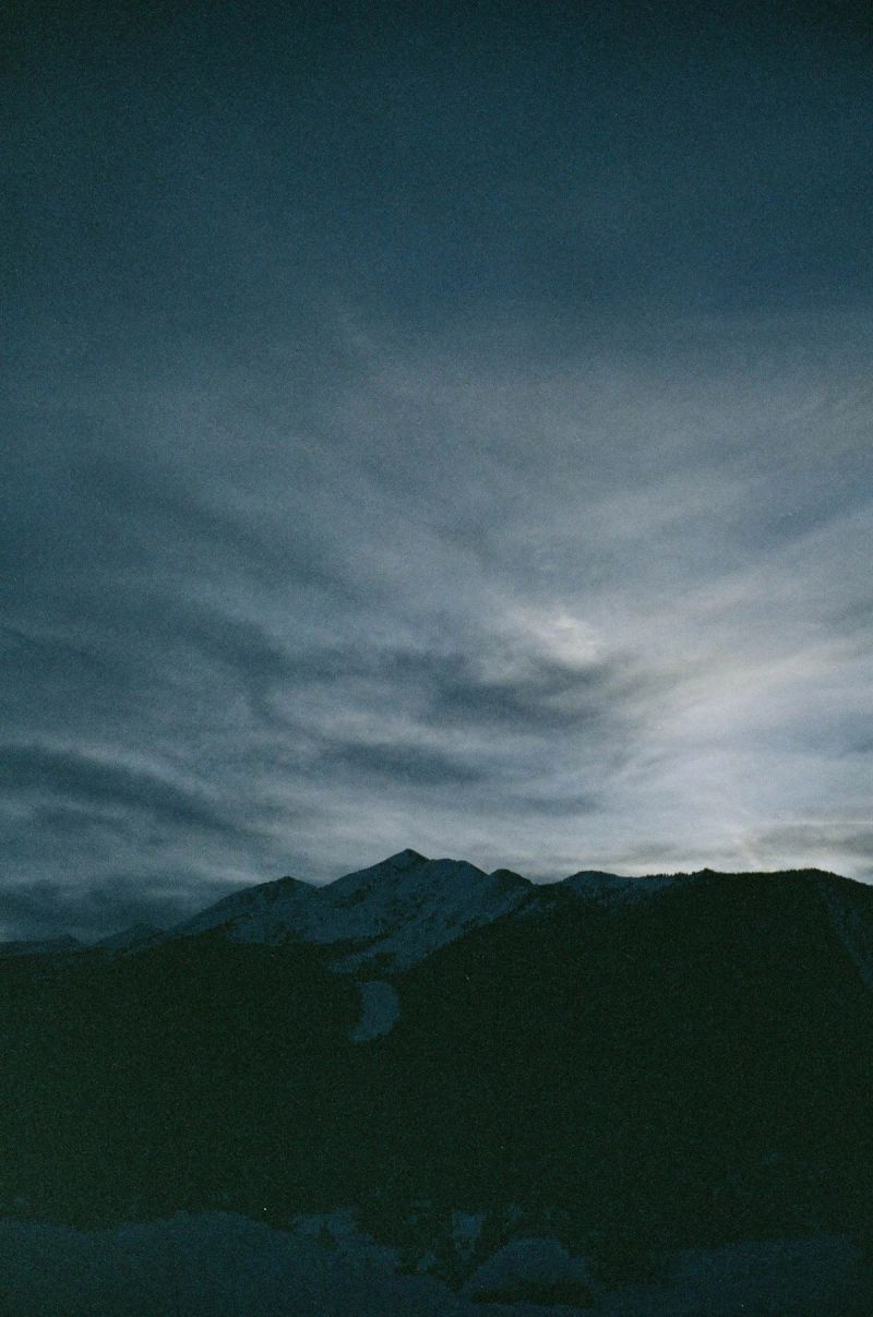Dark mountain range silhouette against dramatic cloudy sky, part of Toyota Olympics film shoot.