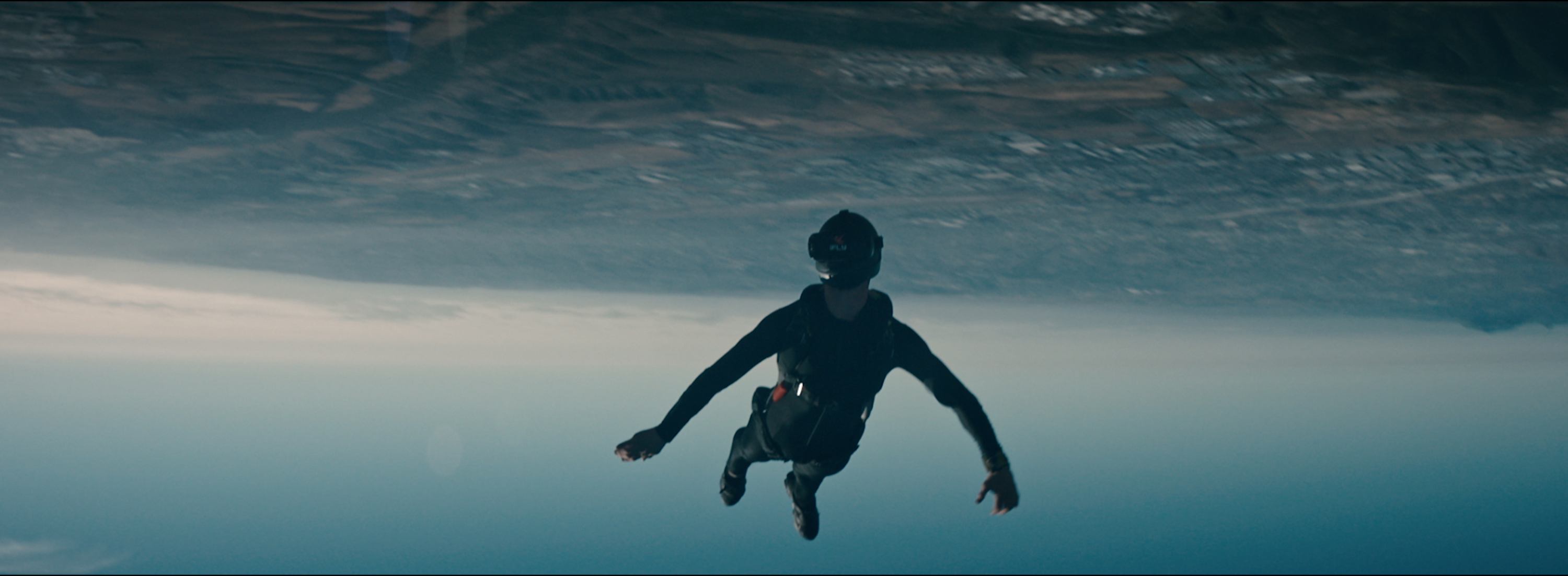 Skydiver in freefall against a vast sky backdrop