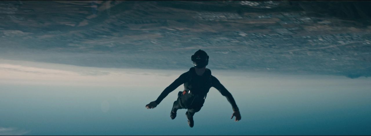 Skydiver in freefall against a vast sky backdrop