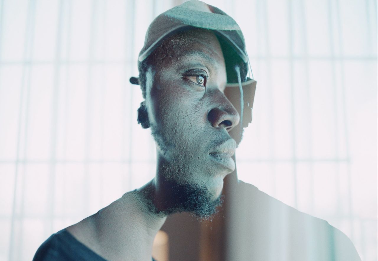 Reggie Jackson in a contemplative pose wearing a cap, captured on film.