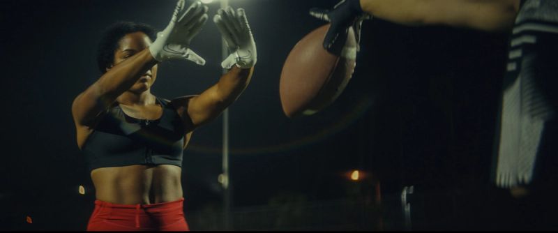 Jen Welter catching a football pass during the Eastbay ConqHer Santia Deck shoot.