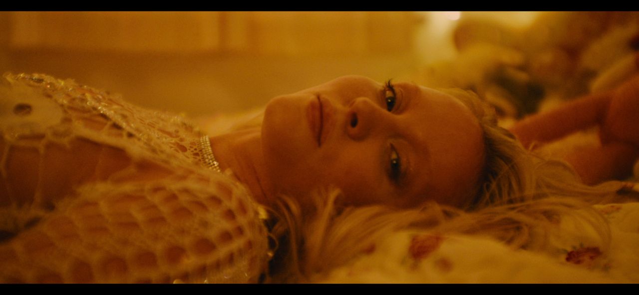 Zara Larsson lying down in warm-toned film photography from End of Time