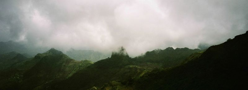 Dramatic mountain landscape shrouded in clouds and mist