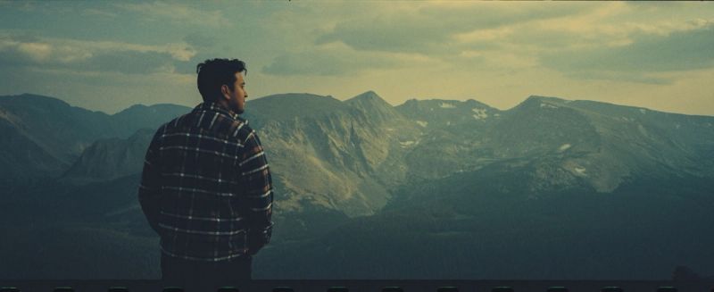 Cinematographer stands before Colorado Rocky Mountain National Park peaks shot on Kodak Portra.